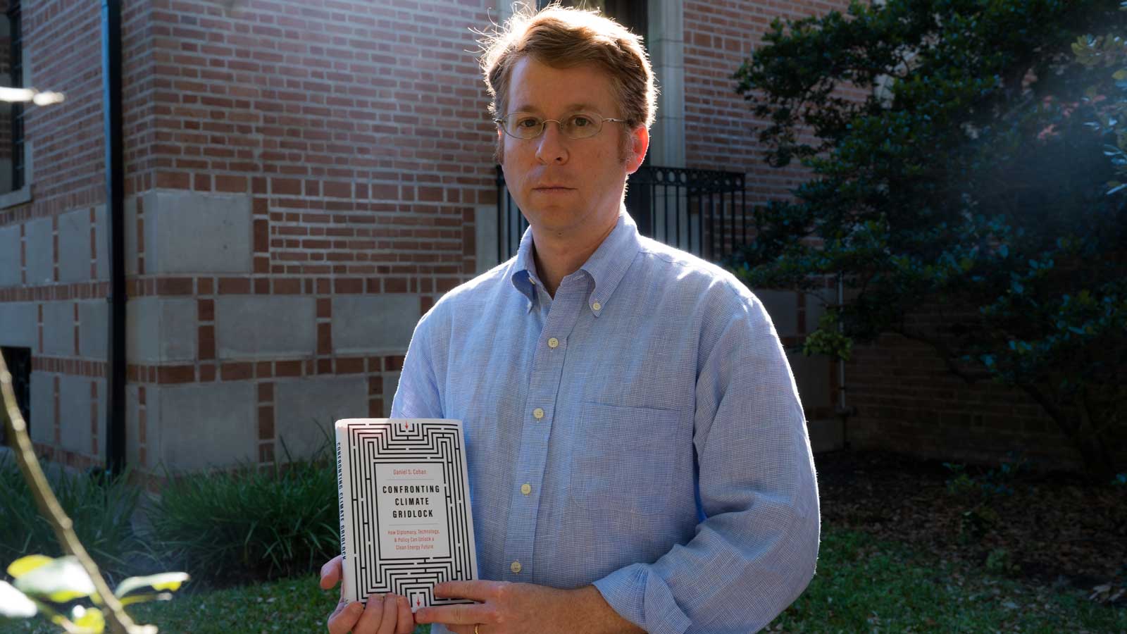 Daniel Cohan holds up copy of new book.